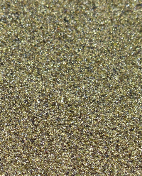 The sand is actually greenish gold. The color is because of olivine in the cinder cone that is being eroded to form the beach sand. Green sand